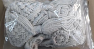 white macrame wall hanging storage